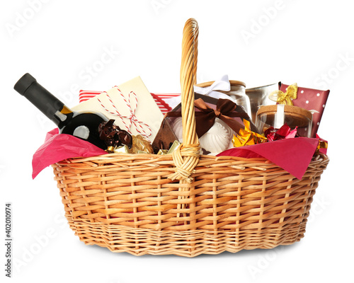 Tableau sur toile Wicker basket full of gifts isolated on white