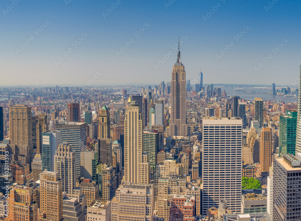 NEW YORK CITY - JUNE 10, 2013: Panoramic aerial view of Manhattan from a city rooftop at sunset