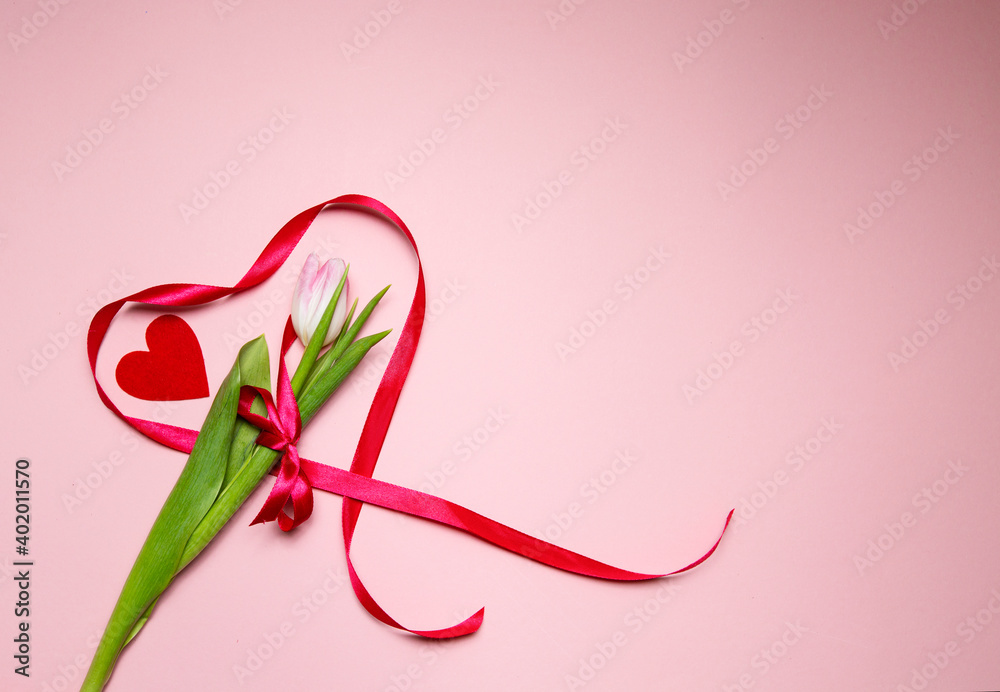 tulip and heart made of red ribbon on a pink background. Valentine's Day tulip and heart made of red ribbon on a pink background. Valentine's Day