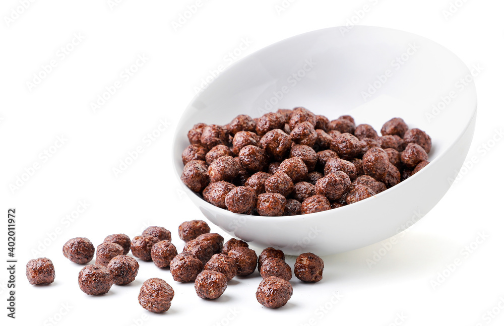 Cereal, chocolate balls spilled out from the plate close-up on a white. Isolated. Cereal, chocolate balls spilled out from the plate close-up on a white. Isolated.