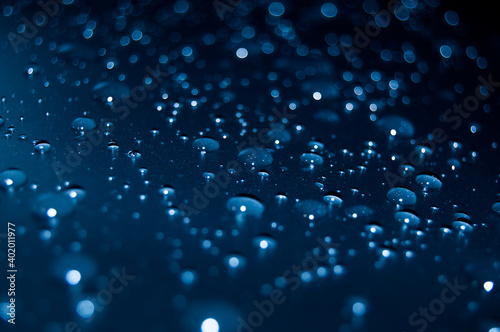 Blue water drops on surface in blue colors concept
