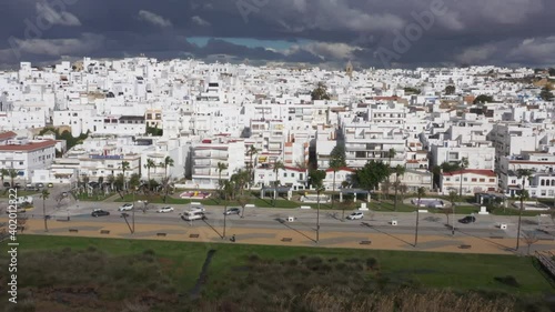 White coast town in Andalusia seen from above drone view. Conil de la Frontera with Paseo Maritimo aerial sight