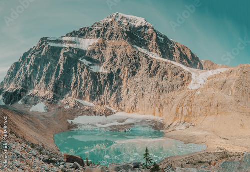 Mount Edith Cavell towers over Cavell Glacer and and the turquoise waters of Cavell Pond with Angel Glacier above, located in the Athabasca River and Astoria River valleys of Jasper National Park.