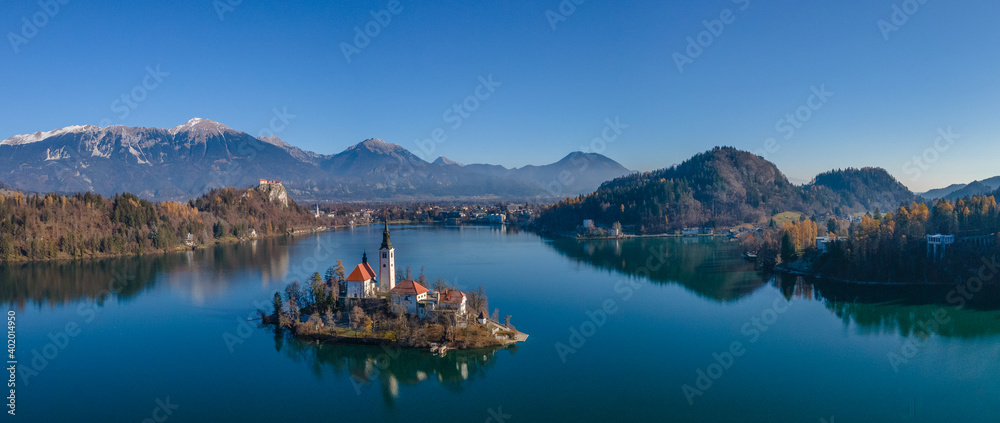 Aerial panoramic view of Lake Bled island in autumn colours, Aerial drone photography, Slovenia