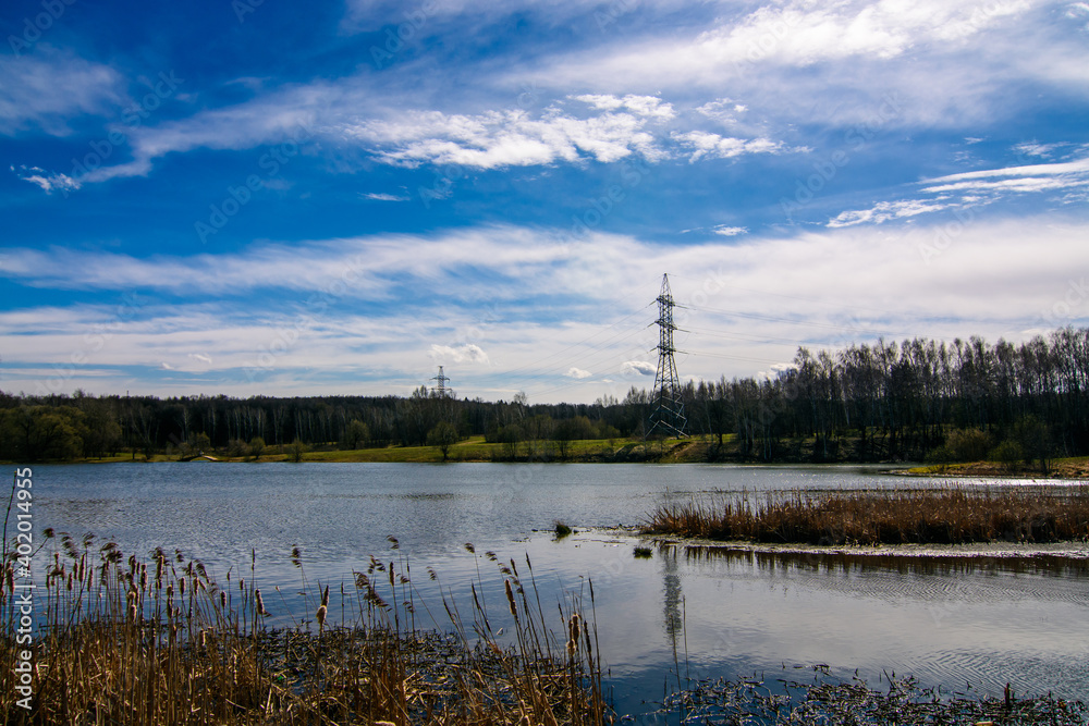landscape with lake and power line tower landscape with lake and power line tower