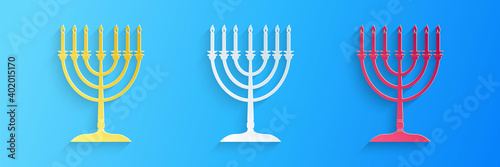 Paper cut Hanukkah menorah icon isolated on blue background. Religion icon. Hanukkah traditional symbol. Holiday religion, jewish festival of Lights. Paper art style. Vector.