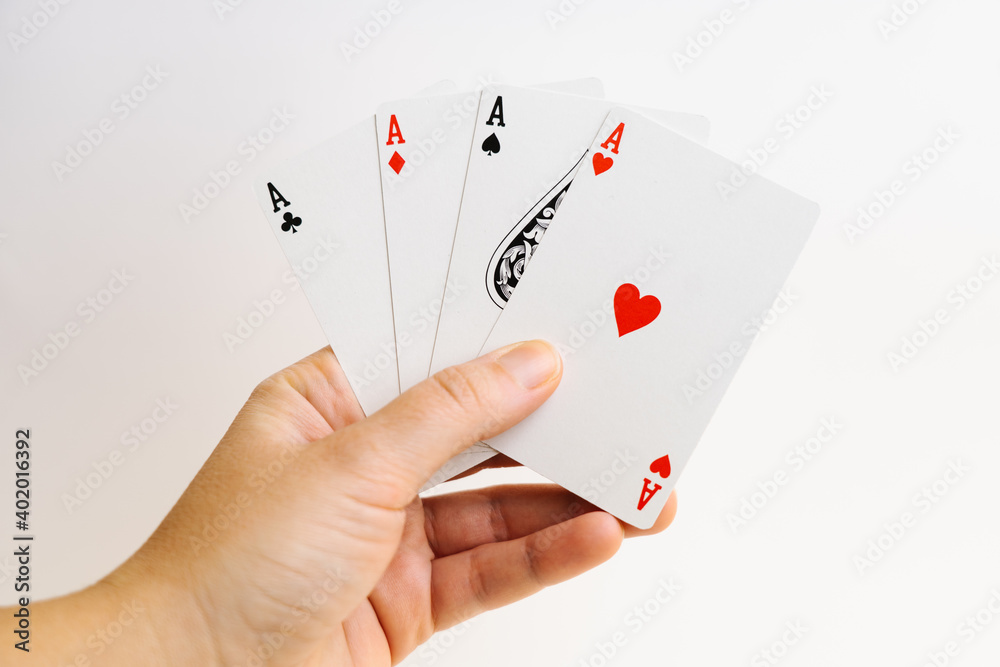 Poker aces in hand isolated on white background Poker aces in hand isolated on white background
