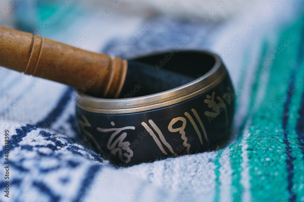 woman doing alternative medicine playing tibetan singing bowls that heals