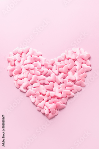 Pink romantic heart on pink background. Vertical monochrome greeting Valentine's day card. Love concept.