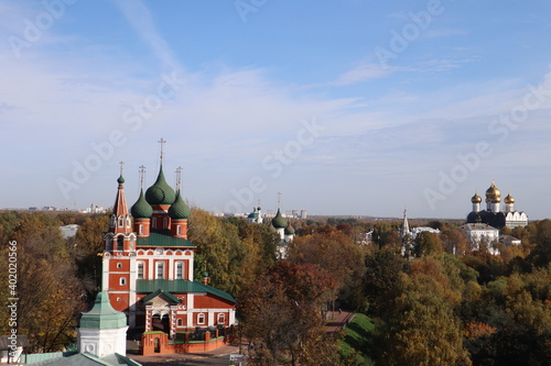 Top view, from the bell tower on the city, on the church among the parks, beautiful city landscape, religion and architecture, history, culture and art 