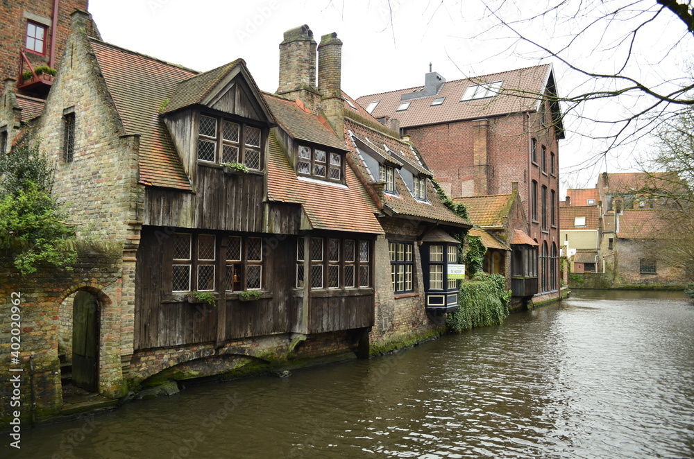 Wooden house in Bruges, by the canal, Belgium.