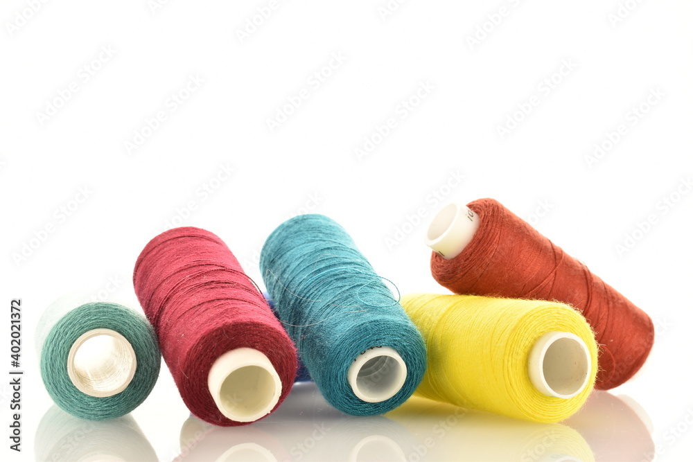 Several spools of colored thread, close-up, isolated on white. Several spools of colored thread, close-up, isolated on white.