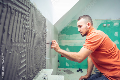 Quadro su tela concentrated tiler installing large format tiles during home renovation