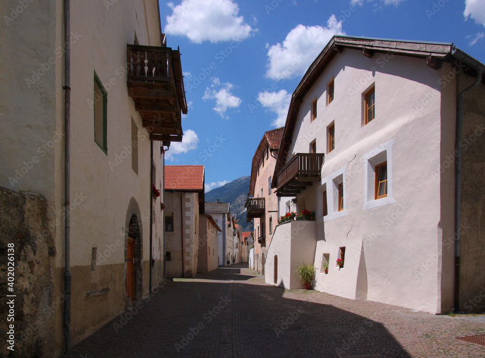 Restored medieval old town of Glurns in the Alps with front-gabled massive houses with arcades in Laubengasse street, Vinschgau region, South Tyrol in Italy