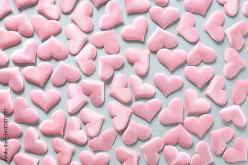 Pattern of pink romantic hearts on blue background. Valentine's day texture. Love concept.