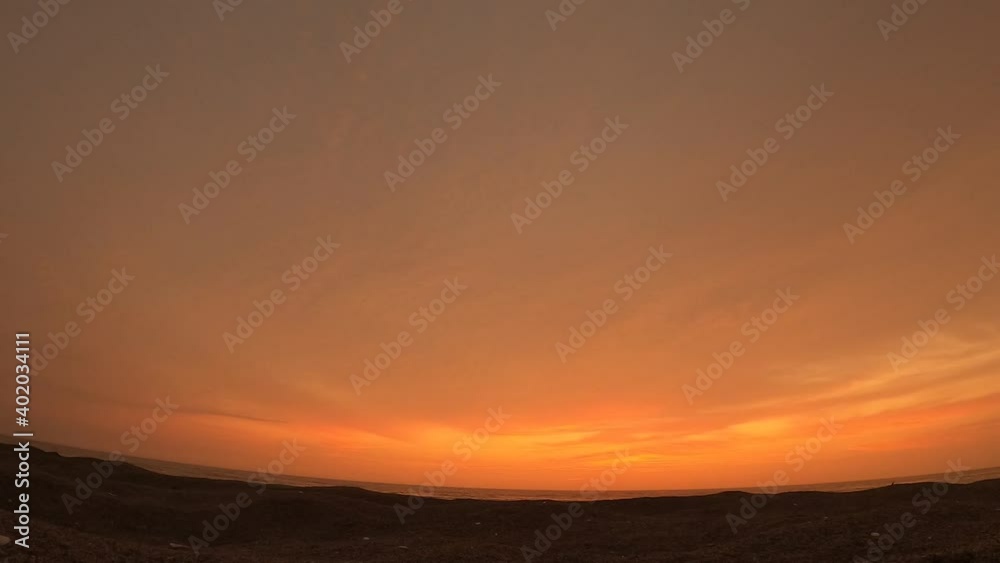 timelapse of dusk on the beach from the sand timelapse of dusk on the beach from the sand