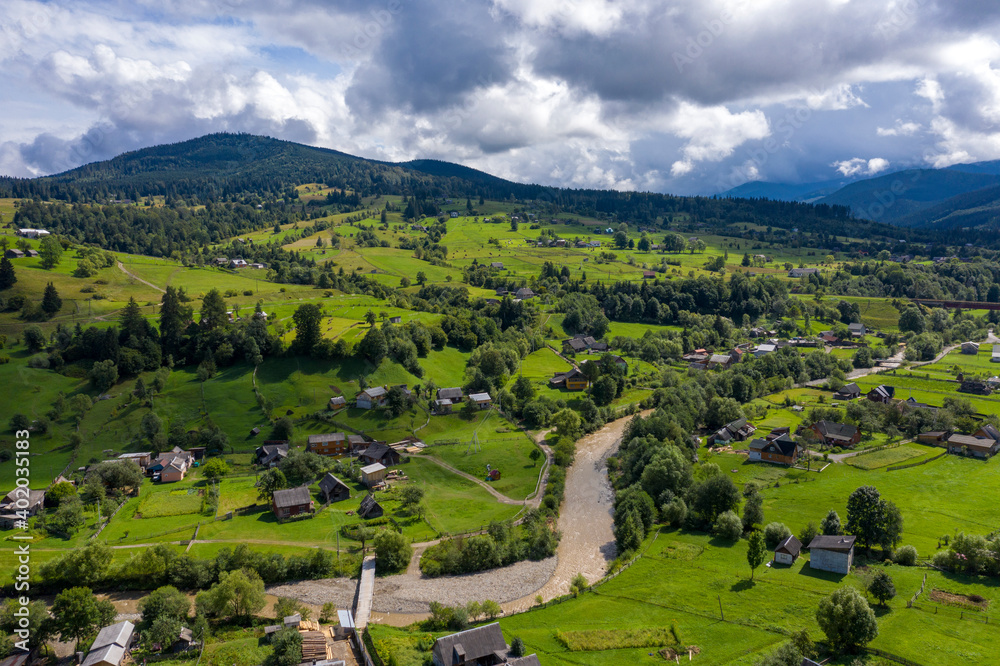Mountains village landscape with River and Beautiful vintage wooden houses aerial view.