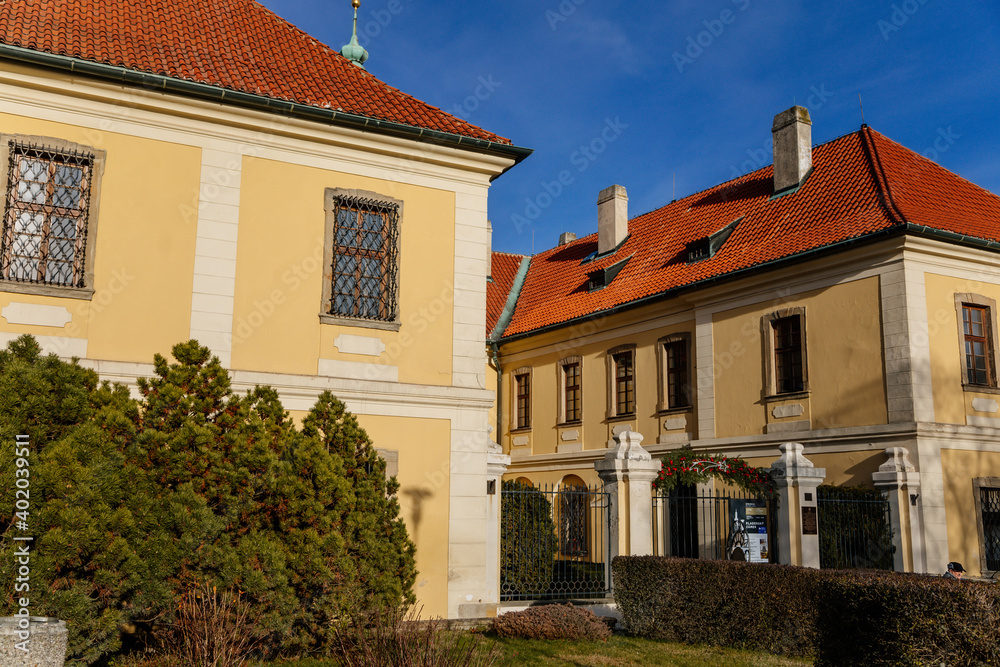 Baroque chateau with clock tower, Castle and town gallery with Christmas decorations in winter sunny day, medieval city Kladno, Central Bohemia, Czech Republic