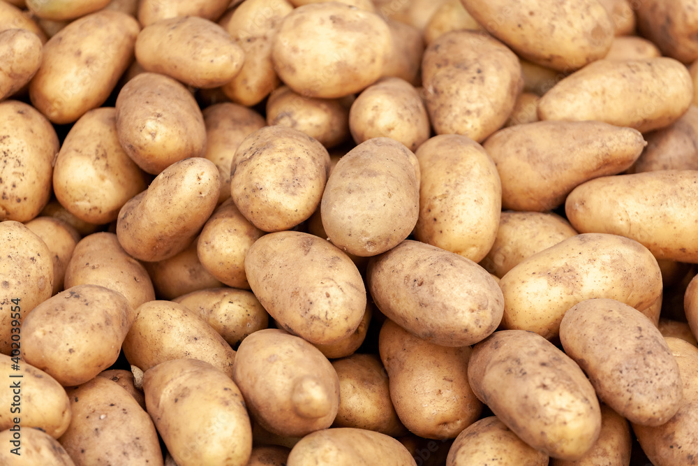 Potatoes on sale at a farmers market stall Potatoes on sale at a farmers market stall