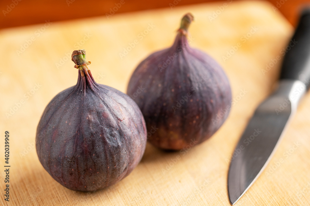 fresh figs and old knife on wooden board fresh figs and old knife on wooden board