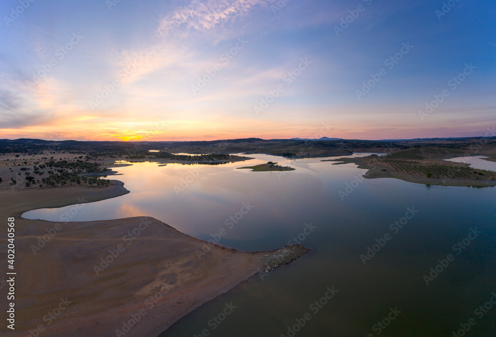 Drone aerial panorama of a dam lake reservoir at sunset in Terena, Portugal