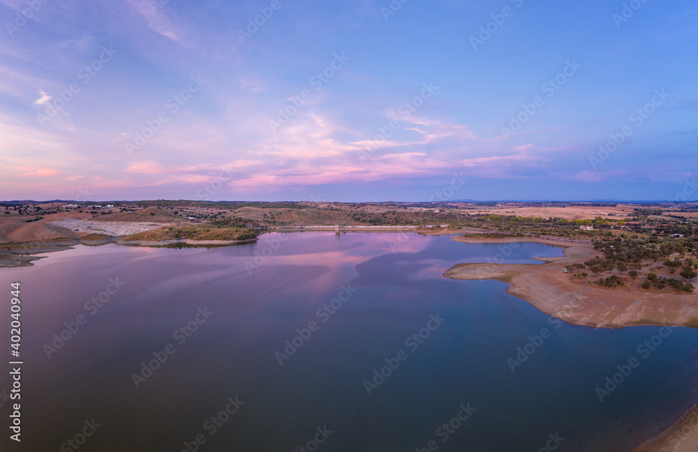 Drone aerial panorama of a dam lake reservoir at sunset in Terena, Portugal