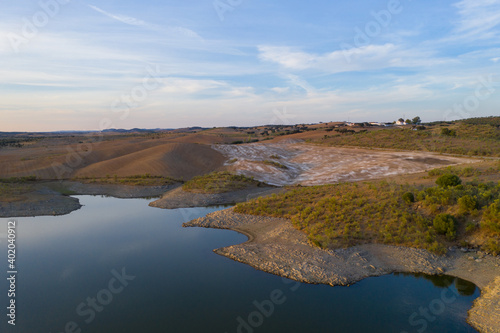 Fototapeta Naklejka Na Ścianę i Meble -  Drone aerial panorama of a dam lake reservoir at sunset in Terena, Portugal