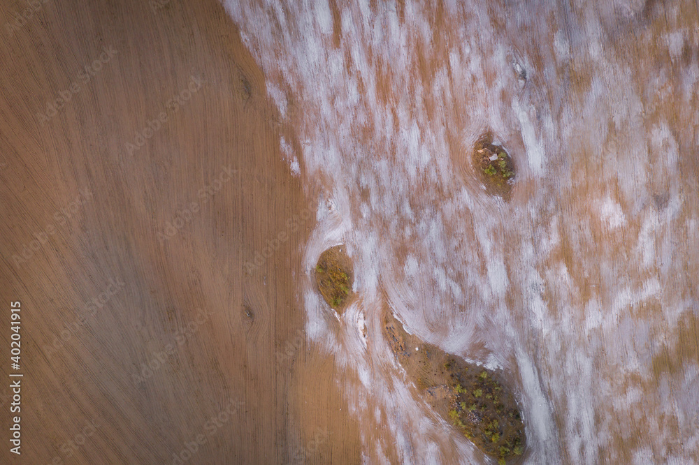 Fototapeta premium Drone top aerial panorama of a desert like hill landscape with marble stones dust at sunset in Terena near a dam lake reservoir, Portugal