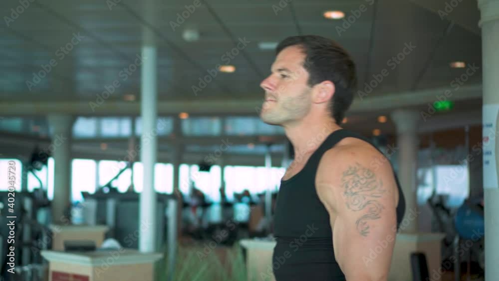 Muscle man practice Dumbbell Front Raise in the Gym Muscle man practice Dumbbell Front Raise in the Gym
