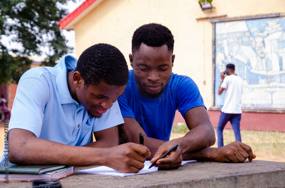 african student studying their books african student studying their books