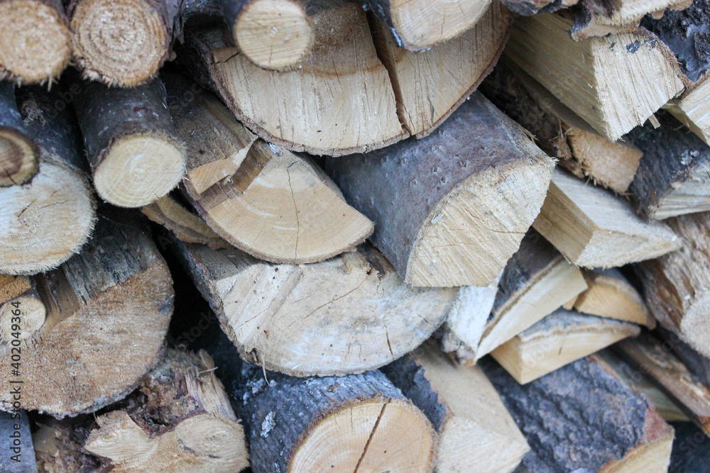 Abstract background with chopped wood in a large heap and stacked in storage piles Abstract background with chopped wood in a large heap and stacked in storage piles