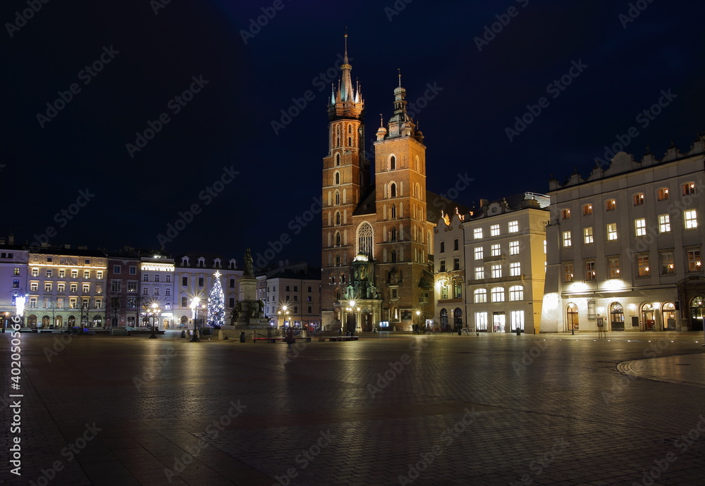 Krakow night cityscape, main market square, saint marys church, christmas tree, empty, without people