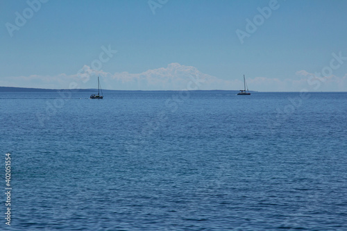 Two yachts sailing in the distance in Adriatic sea. © staclu