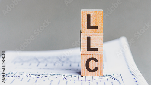 letter of the alphabet of LLC on a grey background. LLC - Limited liability company photo
