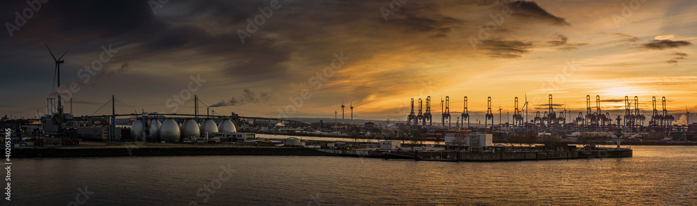 Panorama of the harbor of Hamburg (Süderelbe) with Köhlbrand bridge at sunset