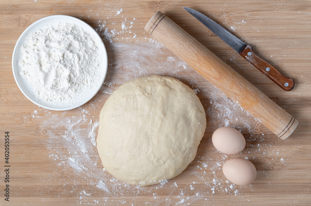 Top view of dough and baking ingredients on wooden table Top view of dough and baking ingredients on wooden table