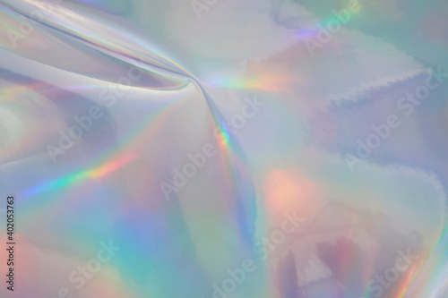 Rainbow halographic wrinkled foil background. Abstract pastel color background. photo