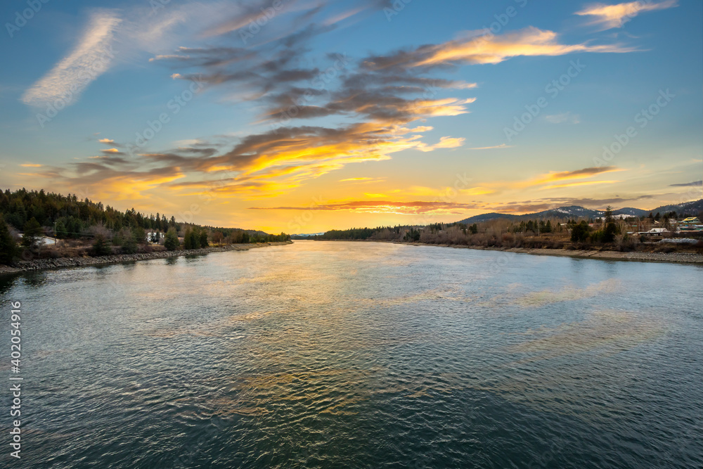 The Priest River seen at sunset from the Wisconsin Street bridge in the town of Priest River, Idaho USA.
