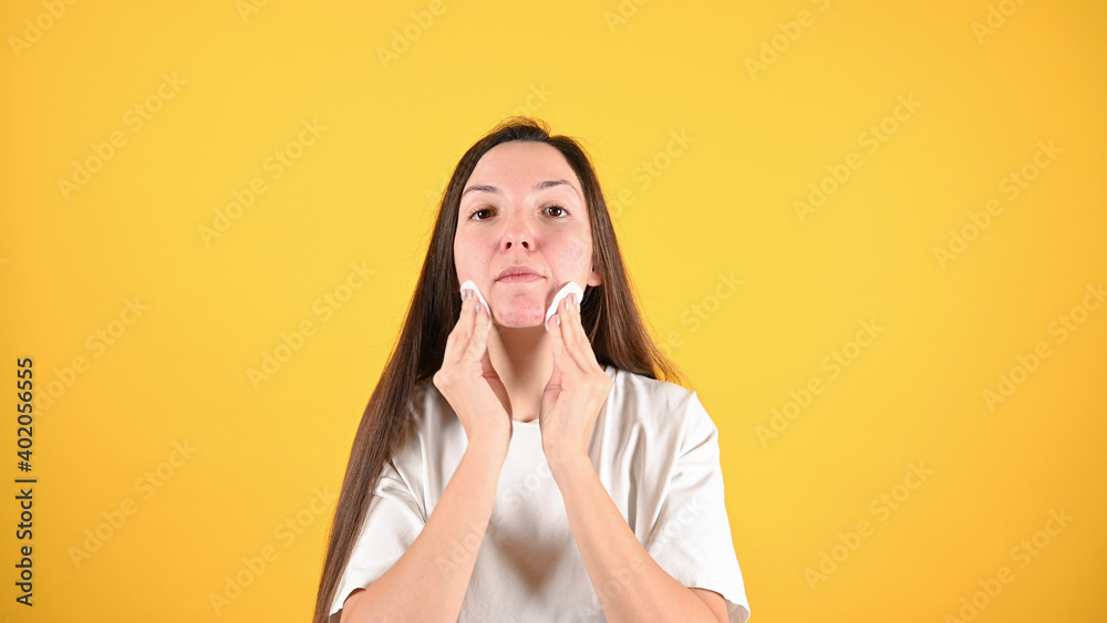 Woman cleaning her face with cotton pads. Daily skincare routine Woman cleaning her face with cotton pads. Daily skincare routine
