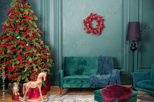 Living room with christmas tree in green color and red decorations