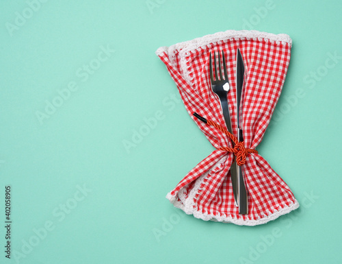 metal fork and knife, green background