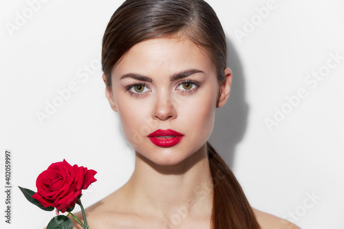 woman with flower Looks forward bare shoulders luxury charm 