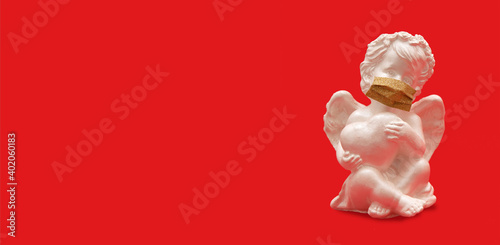 Angel with heart in medical mask on red background - Valentine s Day pandemic concept banner format
