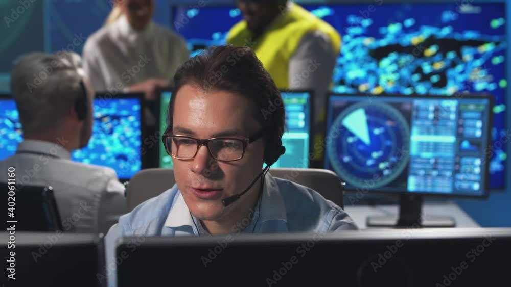 Workplace of the air traffic controllers in the control tower. Diverse team of aircraft control officers works using radar, computer navigation and digital maps. Aviation concept.