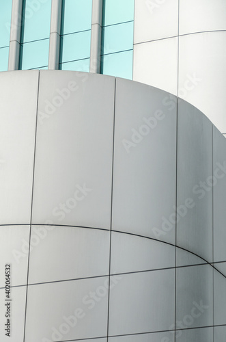 Modern abstract architecture Detail of aluminum walls contrasting with aquamarine tinted glass windows 