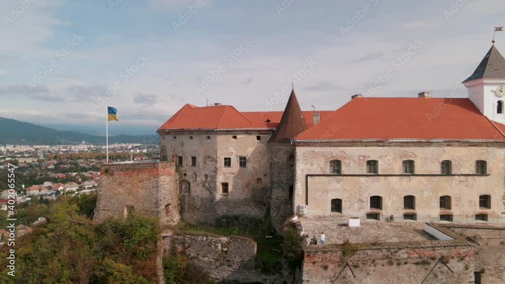 Drone flies over medieval castle on mountain in small european city at cloudy autumn day Drone flies over medieval castle on mountain in small european city at cloudy autumn day