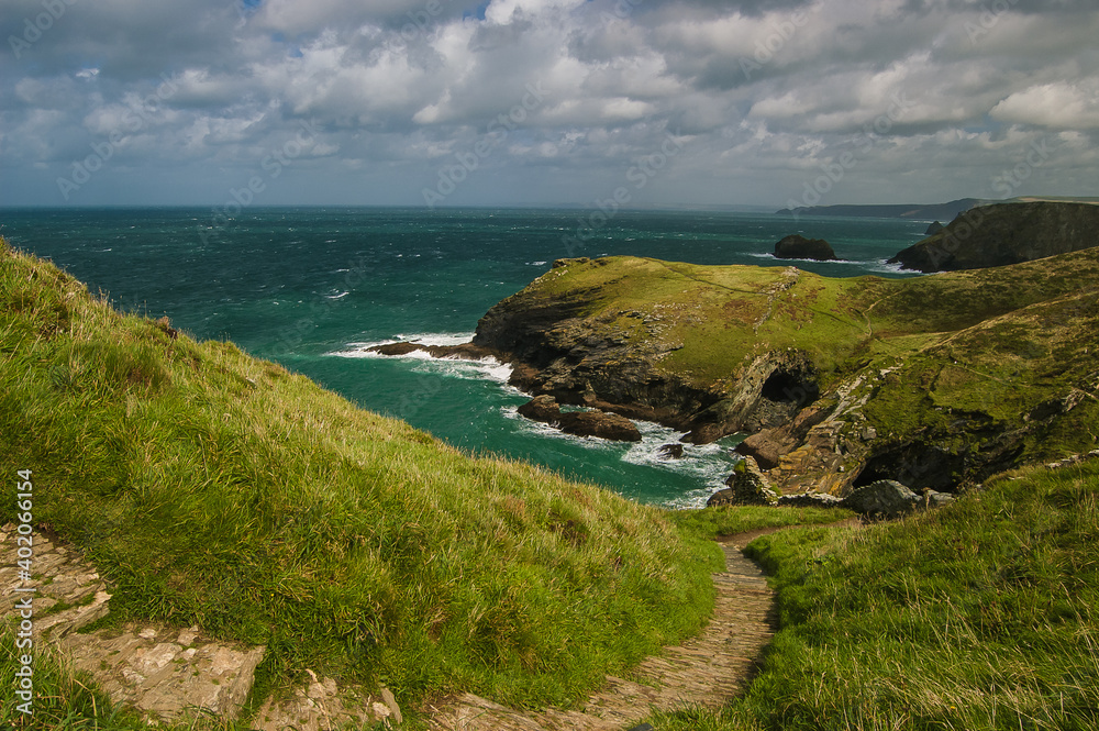 Looking down into the Cove surrounded by cliffs at Tintagel in Cornwall