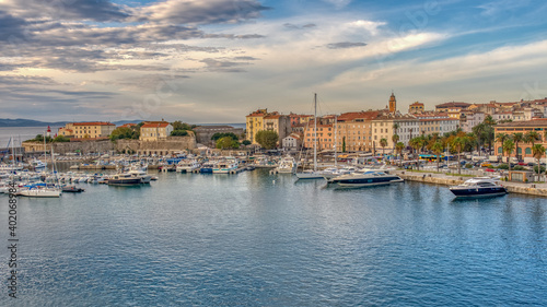 A great sunset harbor view with reflections on the sea from the city and the sky in Corsica, birthplace of Napoleon.