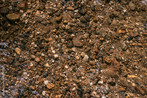 texture background of little rocks in a river