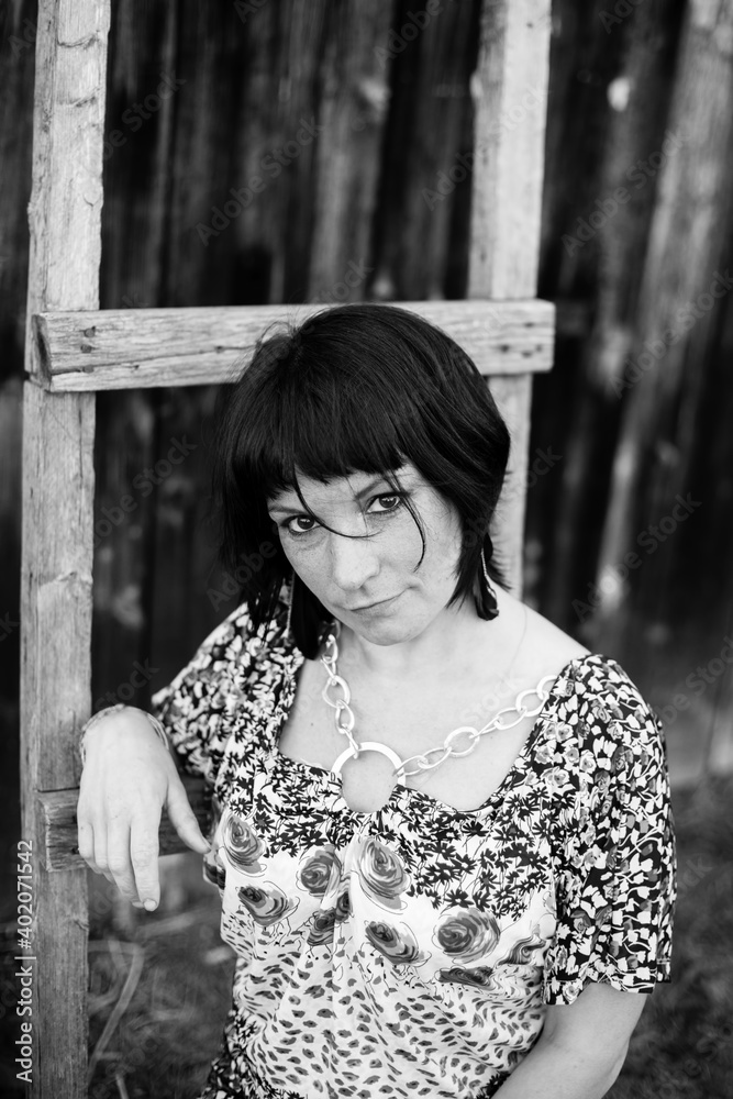 Obraz premium Brunette woman outdoors in the countryside, portrait. Black and white photo.